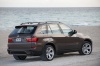 2013 BMW X5 xDrive50i in Sparkling Bronze Metallic from a rear right three-quarter view